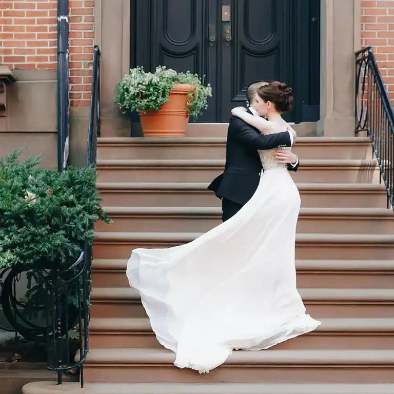Bride and groom sharing their wedding day first look on a picturesque porch stoop in New York City