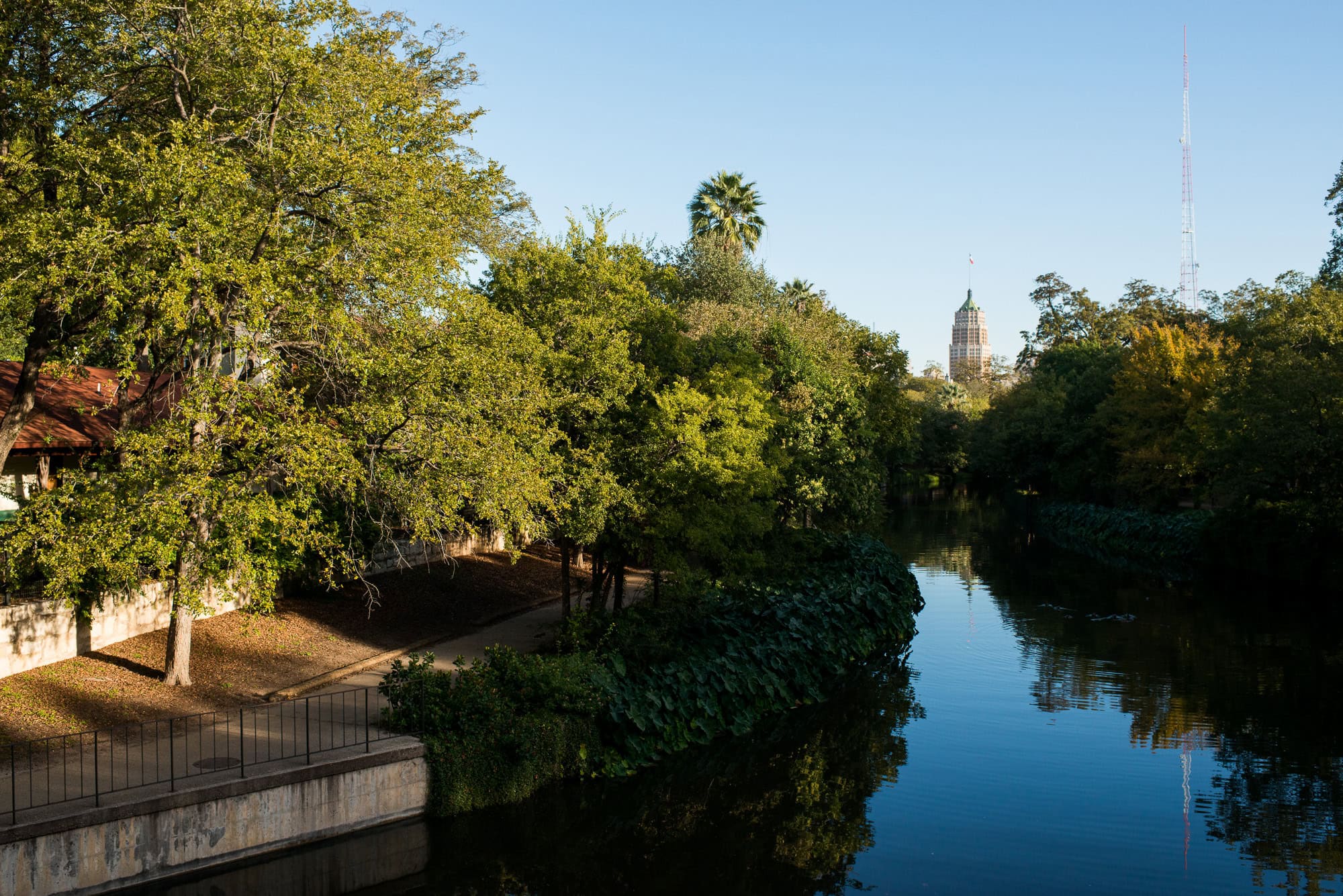 Vanessa & Matthew's Downtown San Antonio Engagement Session | morning view of the San Antonio river, jogging path, and Tower Life building