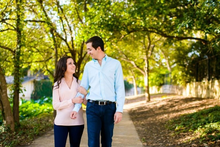 Vanessa & Matthew's Downtown San Antonio Engagement Session | couple walking down a backlit path on the San Antonio river