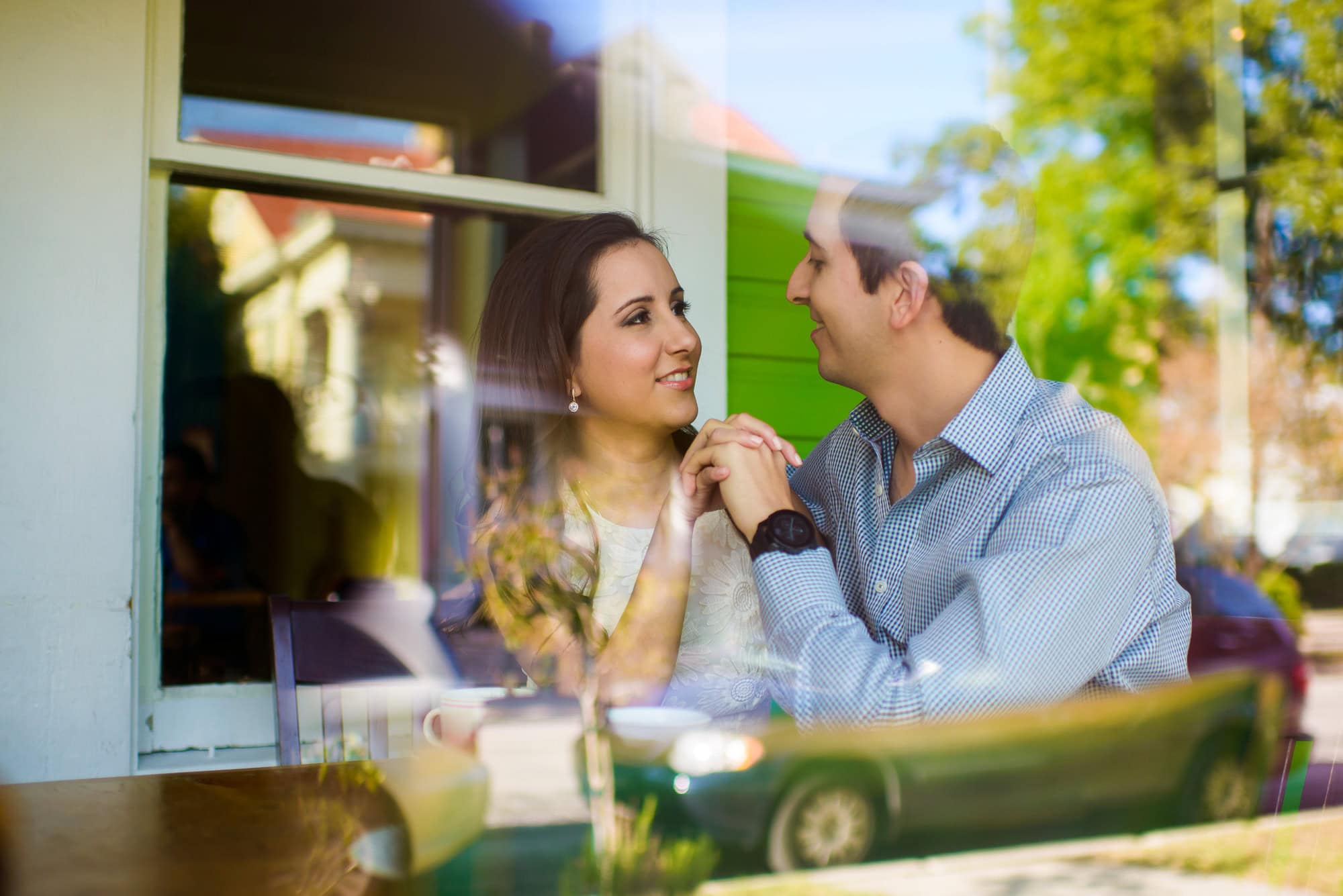 Vanessa & Matthew's Downtown San Antonio Engagement Session | View of couple sharing a moment through the window of a coffee shop