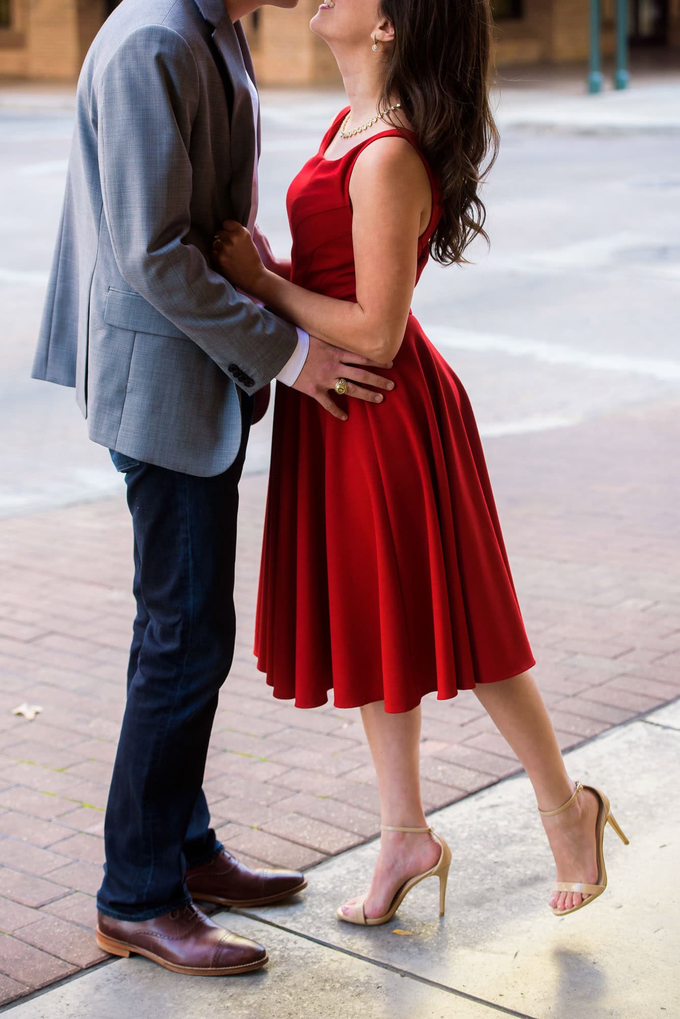Vanessa & Matthew's Downtown San Antonio Engagement Session | woman on tippy toes about to kiss her man