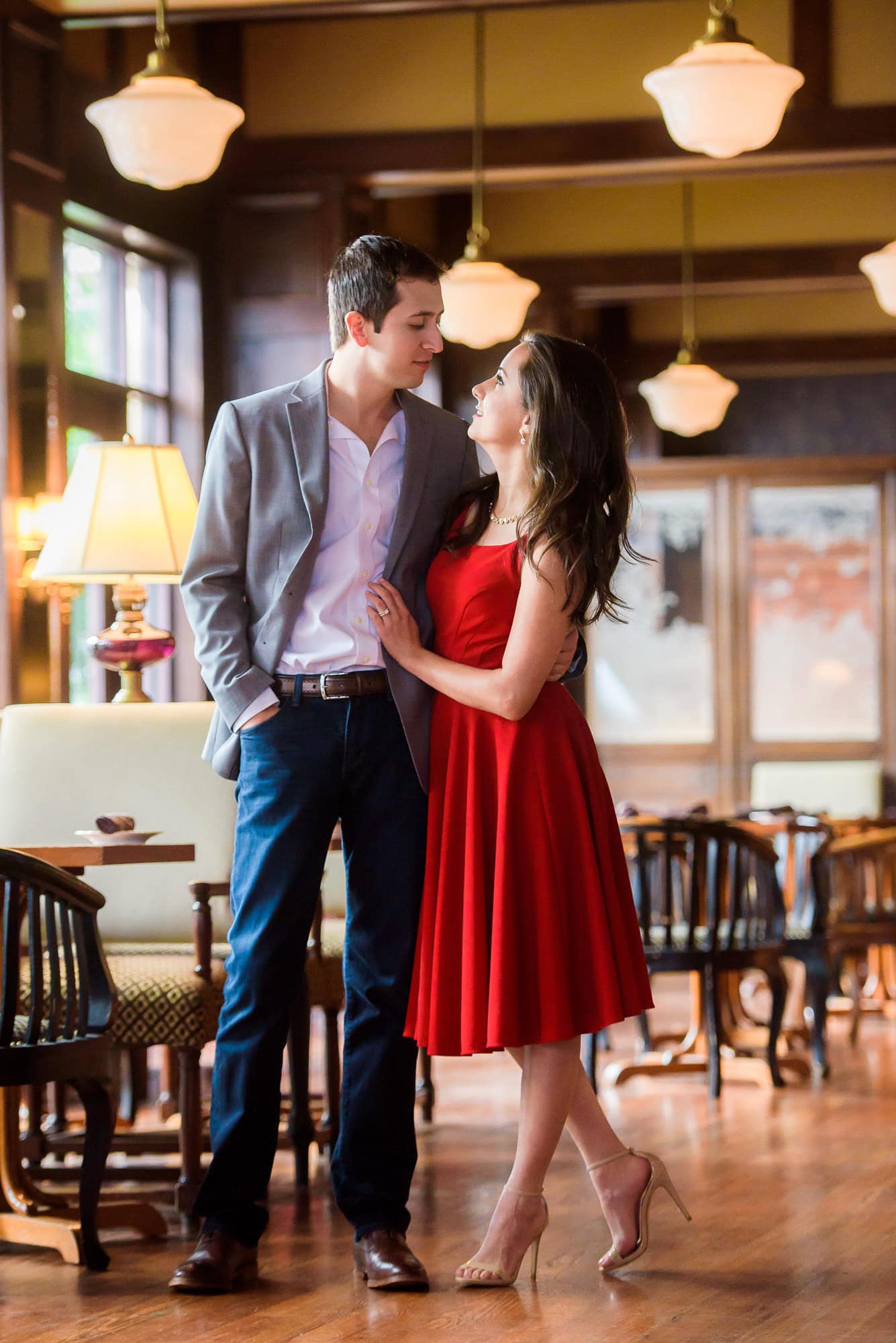 Vanessa & Matthew's Downtown San Antonio Engagement Session | couple share a loving look standing in the dining room of Bohanan's where she said yes!