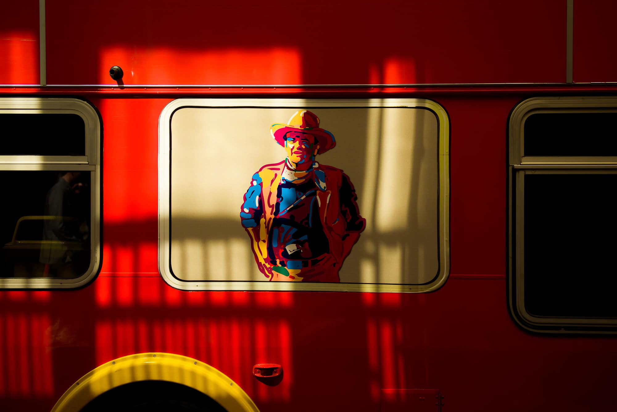 Vanessa & Matthew's Downtown San Antonio Engagement Session | John Wayne art on bus